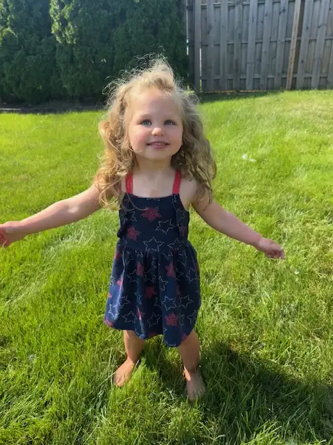 Child playing on a pest-free lawn in Northeast Ohio prepared for mosquito and tick season