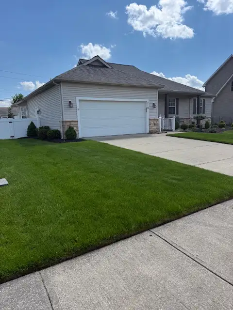 Healthy green lawn in front of a Brunswick, Ohio home treated by Field of Dreams Lawn Care